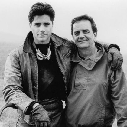 William John Stamos wearing t-shirt and jacket.